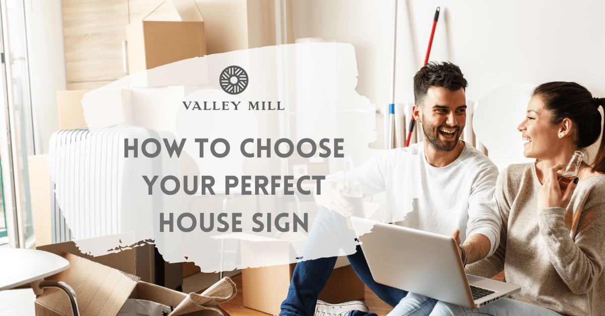 couple working together designing a new house sign on their laptop