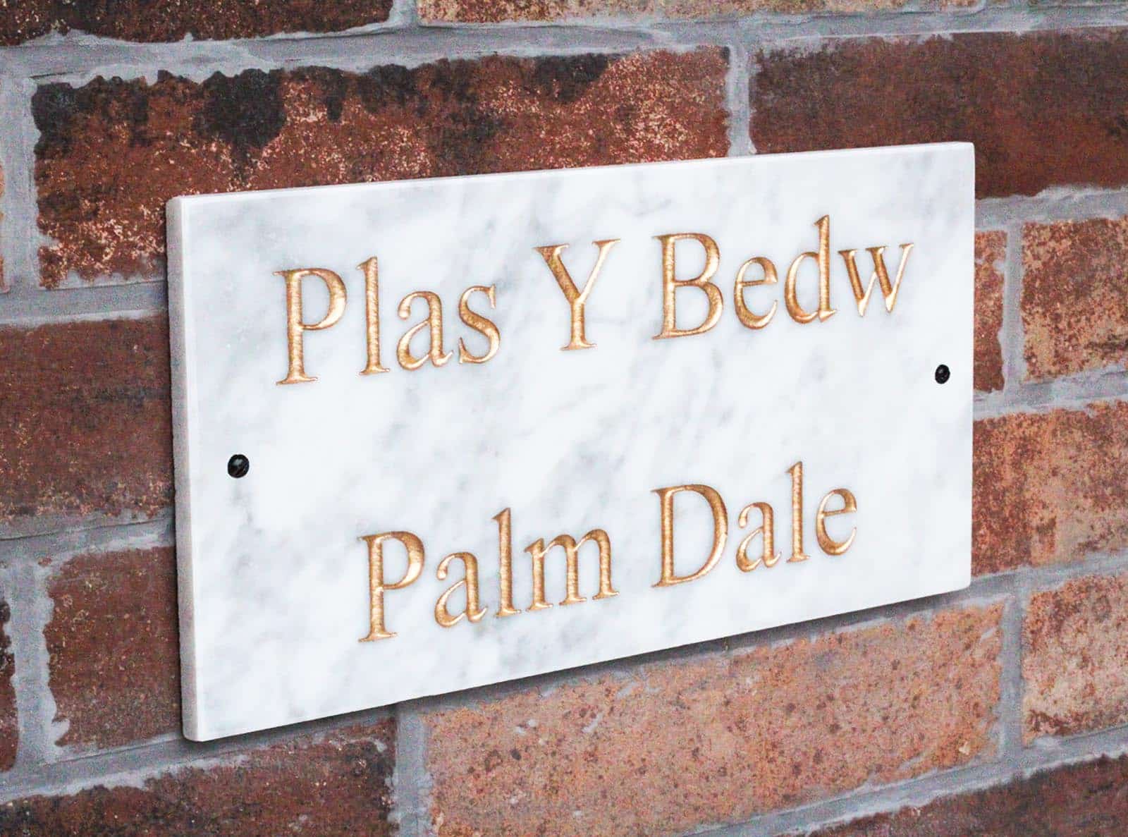 Marble House Sign on a brick wall