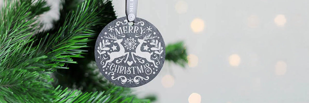 Round Slate Christmas Decoration with Christmas Design engraved on to it.