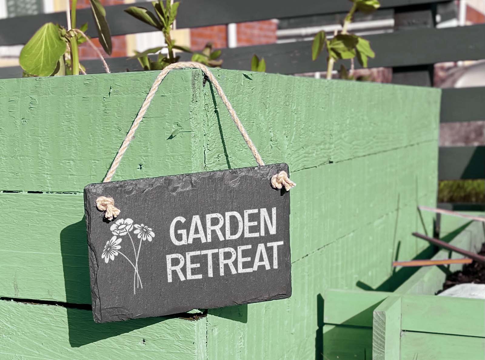 hand cut welsh slate hanging garden sign, engraved with 'garden retreat'
