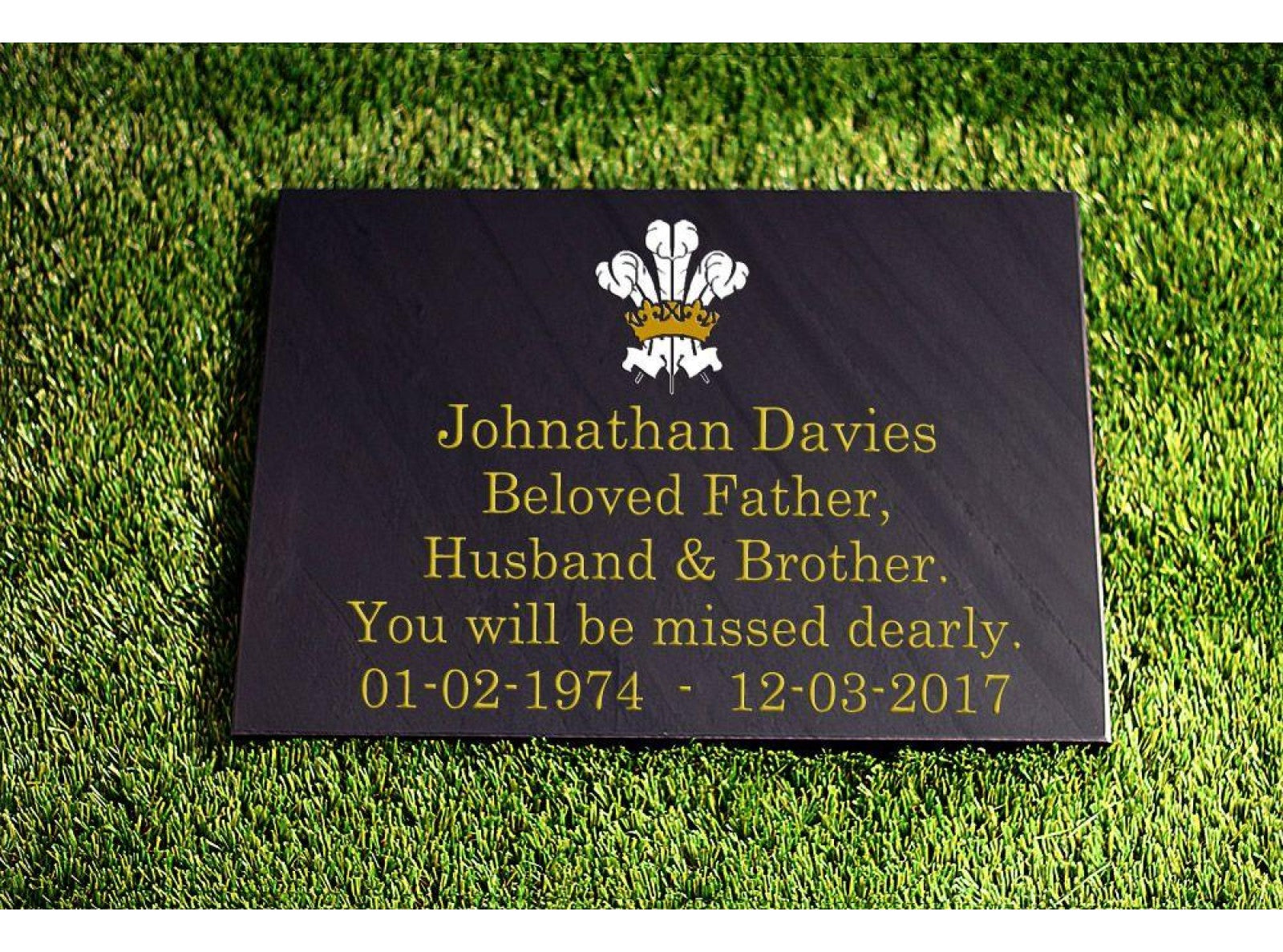 A 300mm x 400mm Welsh slate flat memorial that lays on the ground, sentimental words deep engraved and colour filled on it