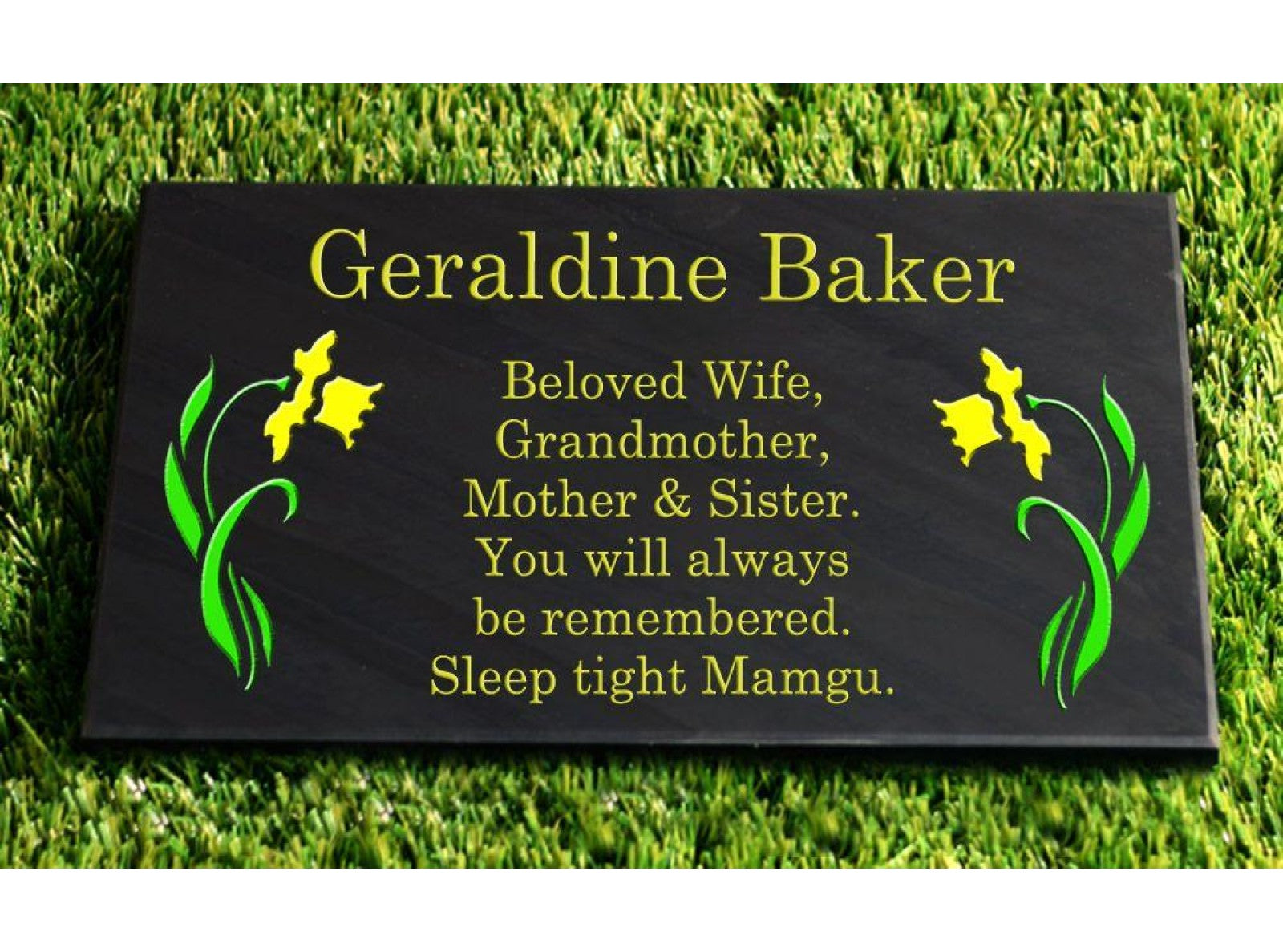 A 400mm x 600mm Welsh slate flat memorial that lays on the ground, sentimental words deep engraved and colour filled on it