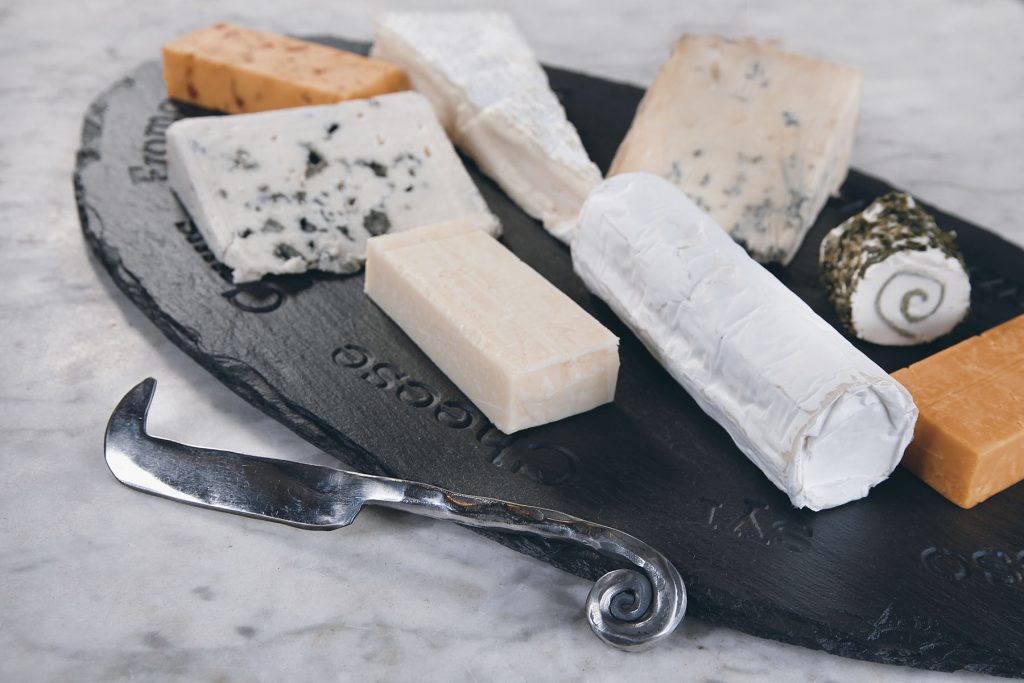 A selection of cheeses served on a Welsh slate cheeseboard. A thoughtful personalised wedding gift.