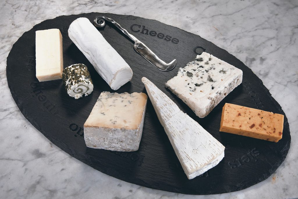 Welsh slate cheeseboard adorned with a stunnning selection of cheeses