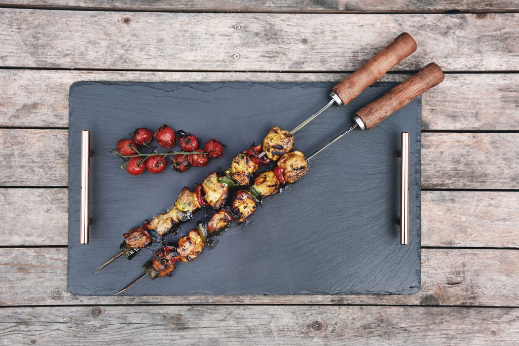Welsh slate serving tray with chicken and pepper kebabs placed on top