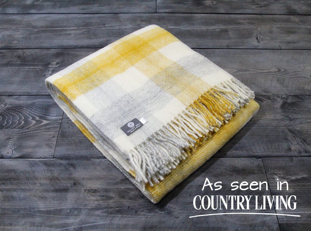 Slate House blankets are made in North Wales and this one has a yellow and grey meadow check colour