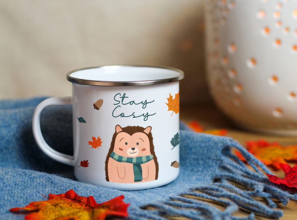 autumn enamel mug design of a cute hedgehog wearing a scarf