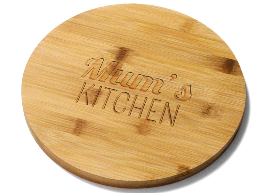 round bamboo board engraved with the words mum's kitchen