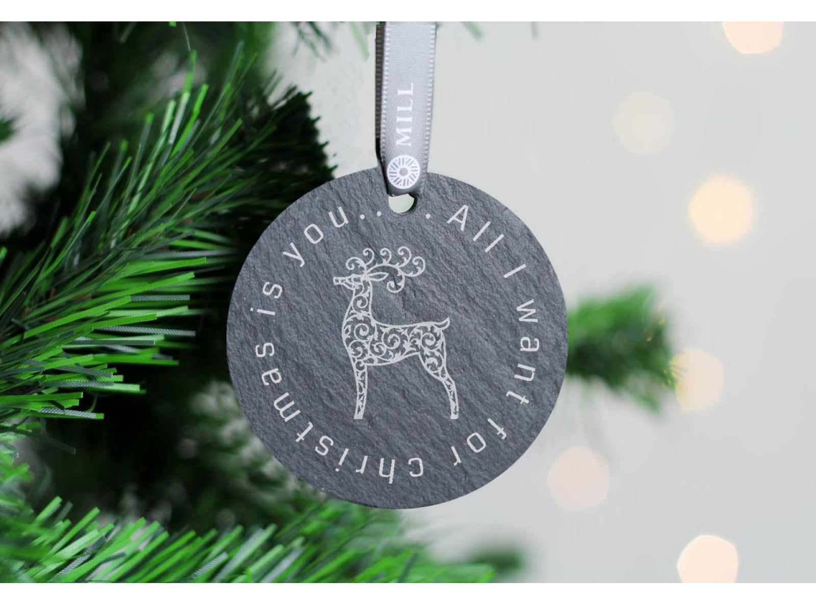 Round welsh slate christmas tree decoration with reindeer design on