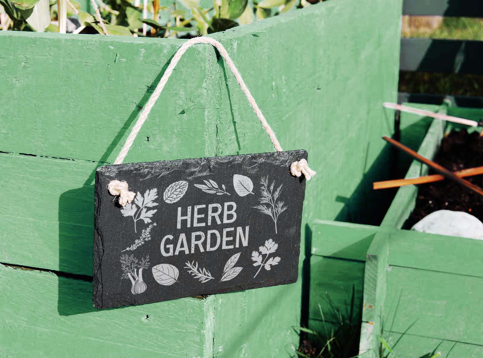 hand cut welsh slate hanging garden sign, engraved with 'herb gardent'